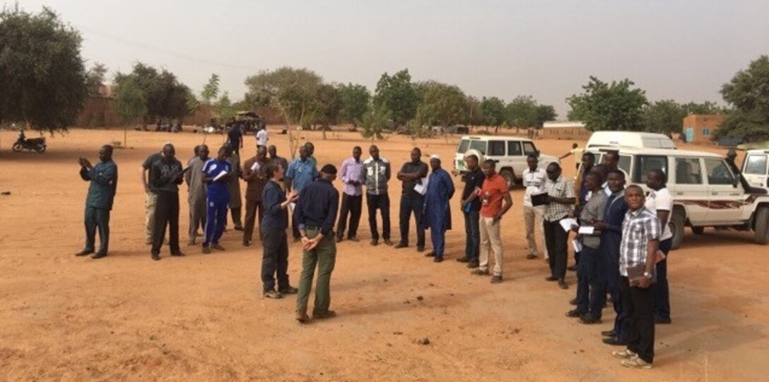 AFOSI 25 EFIS Op Officer SA Helen Marino discusses security with Nigerian counterparts in Niamey, Niger, as part of the inaugural Defense Threat Assessment Methodology Seminar in Niger Dec. 11-14 and 19-22, 2017.