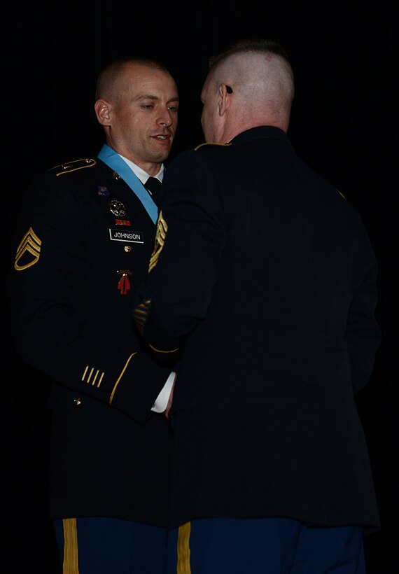 .S. Army Command Sgt. Maj. Drury Puckett III, U.S. Army Aviation School NCO Academy commandant, presents U.S. Army Staff Sgt. Mathew Johnson, Charlie Company, 2nd Battalion, 210th Aviation Regiment, 128th Avn. Bde., instructor writer, with the Sergeant Audie Murphy Club medallion during an induction ceremony at Joint Base Langley-Eustis, Va., Jan. 21, 2018.