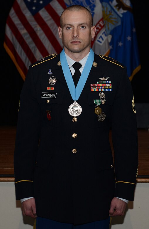 U.S. Army Staff Sgt. Mathew Johnson, Charlie Company, 2nd Battalion, 210th Aviation Regiment, 128th Avn. Bde., instructor writer, stands at attention after being inducted into the Sergeant Audie Murphy Club during a ceremony at Joint Base Langley-Eustis, Va., Jan. 21, 2018.