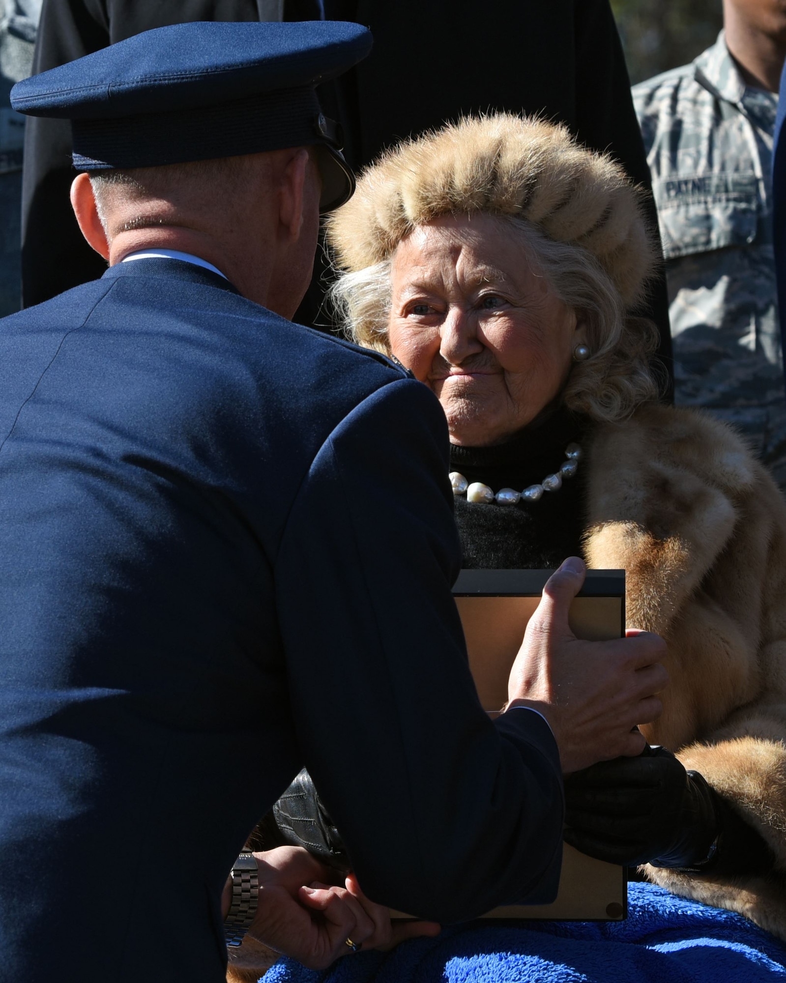 U.S. Air Force Col. Daniel Lasica, 20th Fighter Wing commander, presents Jacqueline Heckel with a Prisoner of War Medal for the sacrifices her late husband, Col. Charles C. Heckel, made as a World War II prisoner of war at Shaw Air Force Base, S.C., Jan. 19, 2018.