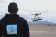 U.S. Air Force 2nd Lt. David Feibus, from Wright-Patterson Air Force Base, Ohio, fly's one his teams DJI S1000 drone during the setup and calibration phase of the event at the Nevada National Security Site, Las Vegas, NV., Dec. 9, 2016. This year teams were given the challenge of solving issues revolving around drones, and are demonstrating their solutions to judges. (U.S. Air Force photo by Wesley Farnsworth)