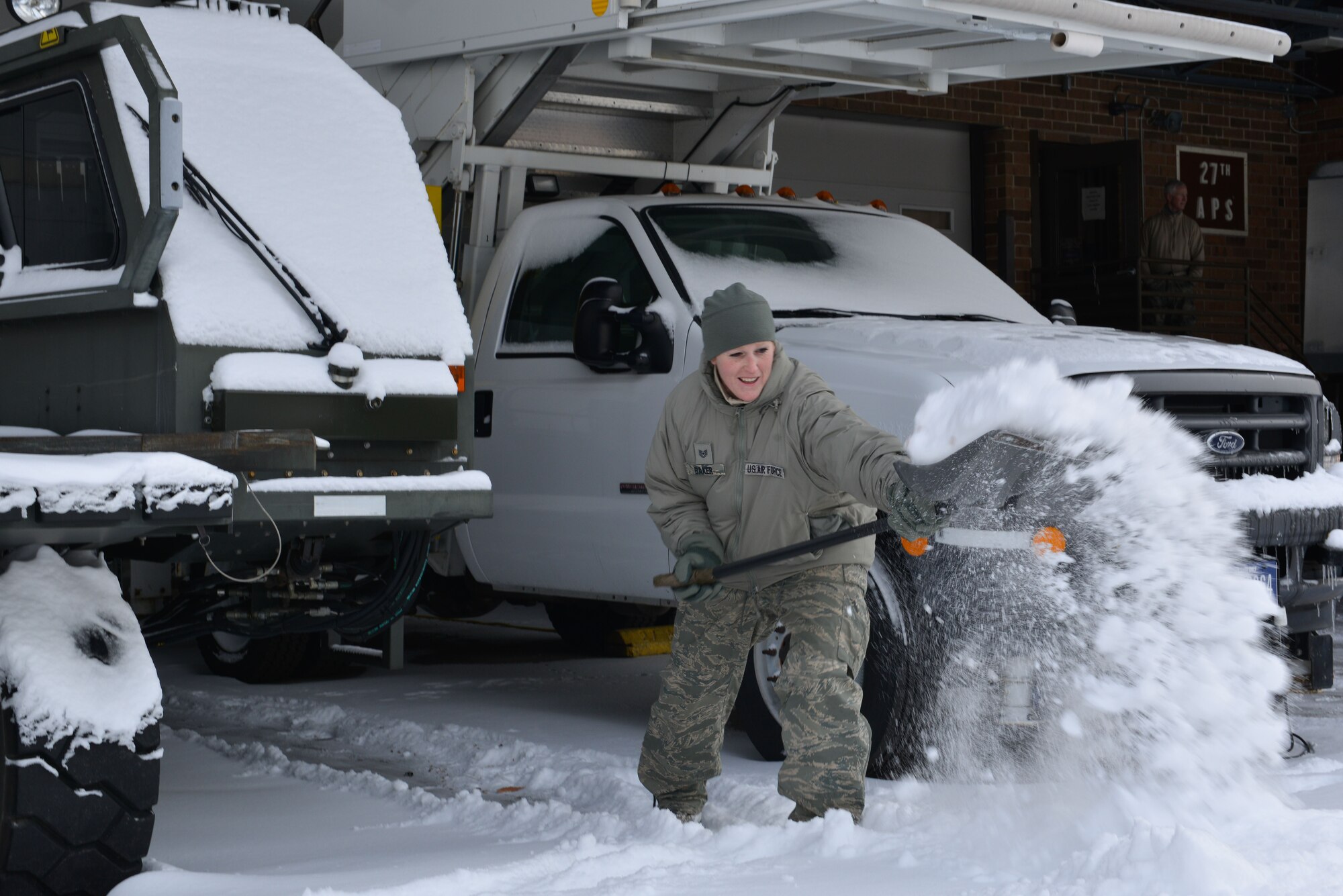 Tech Sgt. Jen Baker, an aerial delivery technician with the 27th Aerial Port Squadron clears a path between vehicles at the Minneapolis-St. Paul Air Reserve Station, Minn., on Jan. 23, 2018. With a delayed report of two hours, members of the 934th immedaitely began the arduous task of digging out from between 10 and 12 inches of snow. (U.S. Air Force photo by Master Sgt. Eric Amidon)
