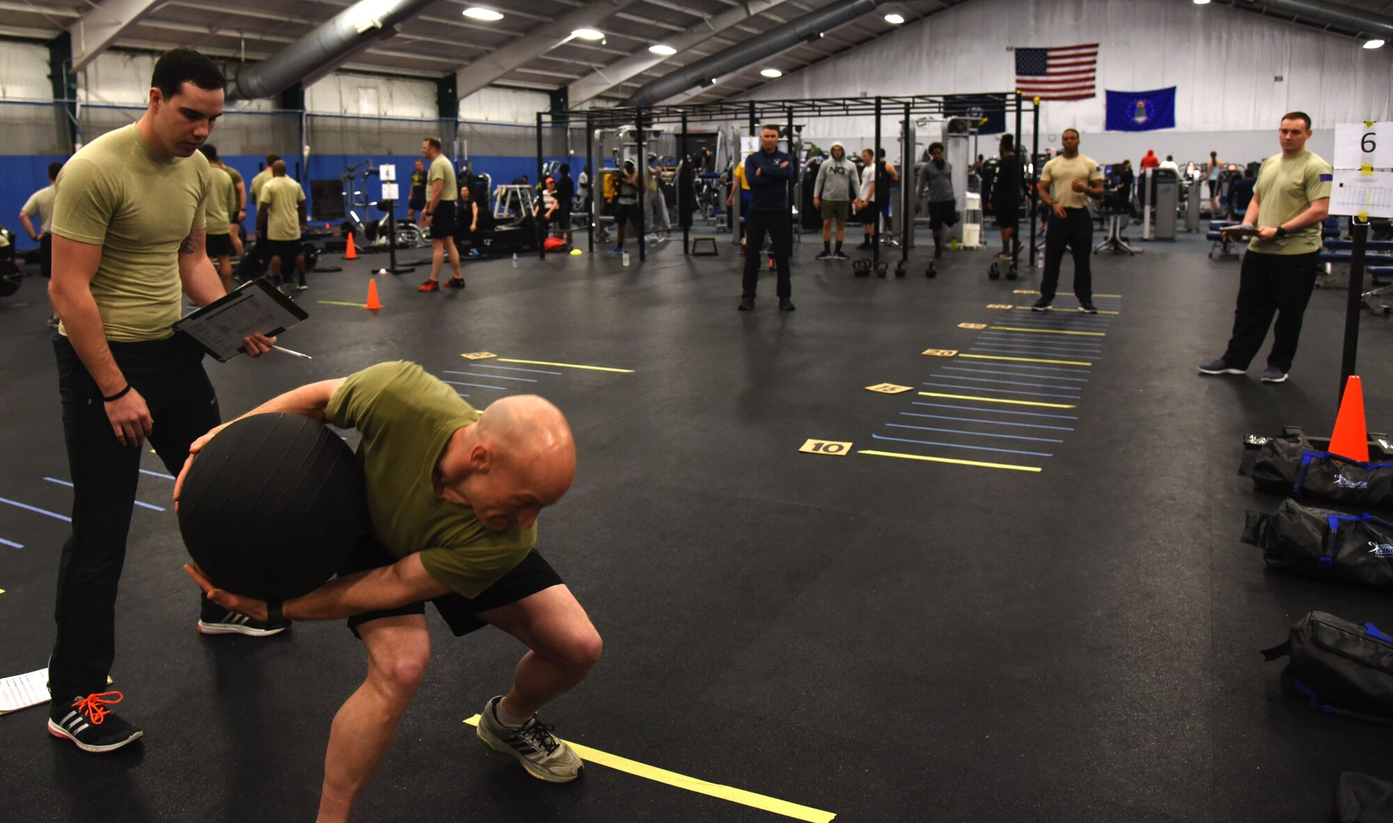 Senior Master Sgt. Kenneth Blakeney (second from left), 9th Air Support Operations Squadron, Fort Hood, Texas, launches a medicine ball at the fitness center at Joint Base Andrews, Md., Jan. 9, 2018. (U.S. Air Force photo by Staff Sgt. Joe Yanik)