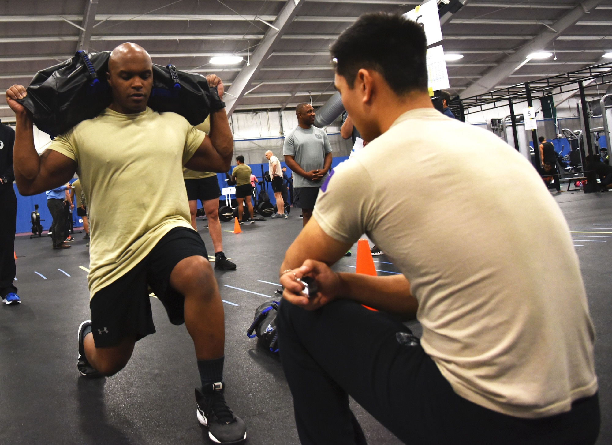 Master Sgt. Eric Rideaux, 9th Air Force, performs lunges using shoulder weights during a fitness demonstration for the Air Force's special operations community at Joint Base Andrews, Md., Jan. 9, 2018. (U.S. Air Force photo by Staff Sgt. Joe Yanik)