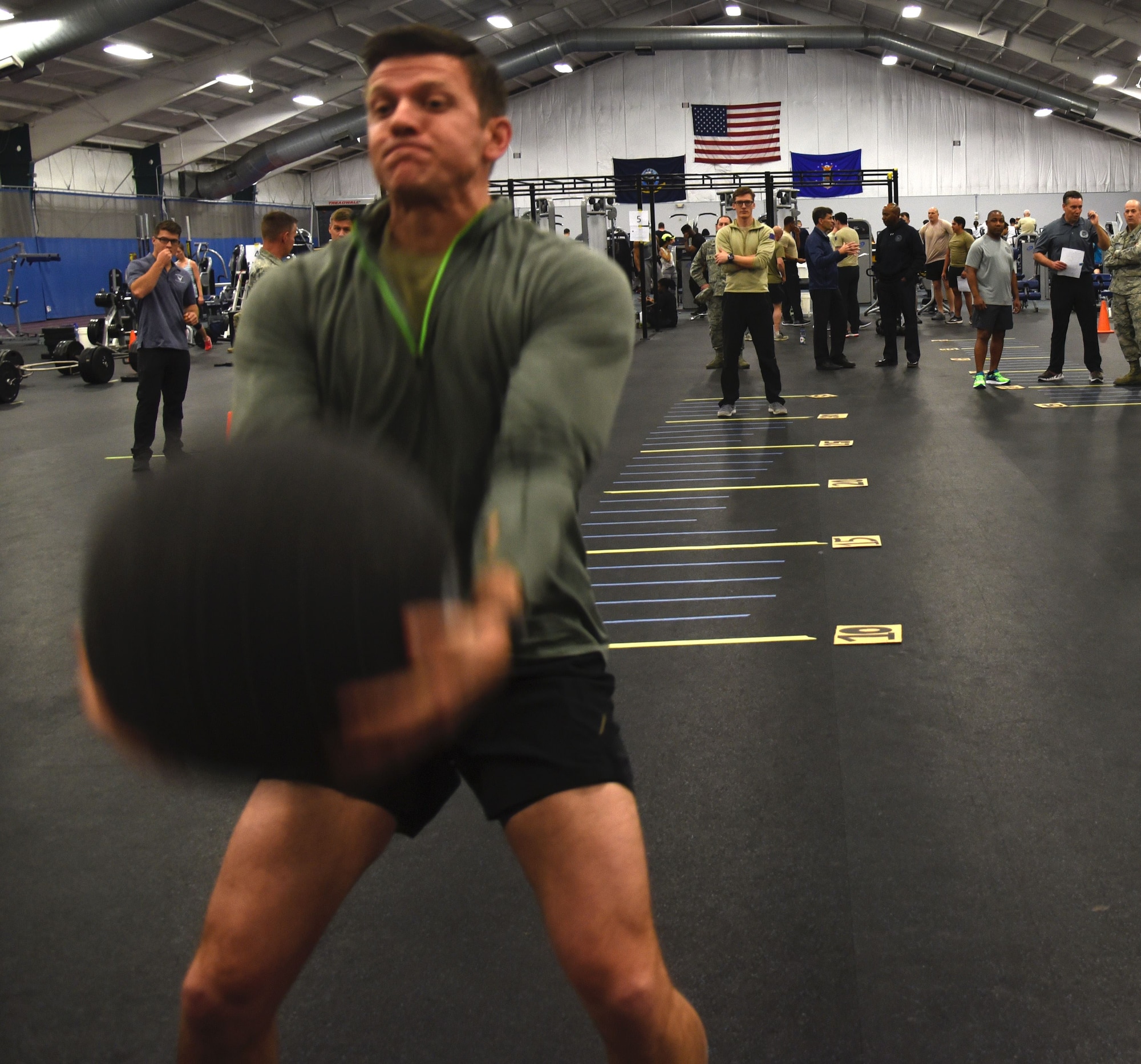 Master Sgt. Paul Foles, 17th Special Tactics Squadron, throws a medicine ball over his head during a strength and agility demonstration as part of the Air Force special operations community's new fitness assessment program at Joint Base Andrews, Md., Jan. 9, 2018. (U.S. Air Force photo by Staff Sgt. Joe Yanik)