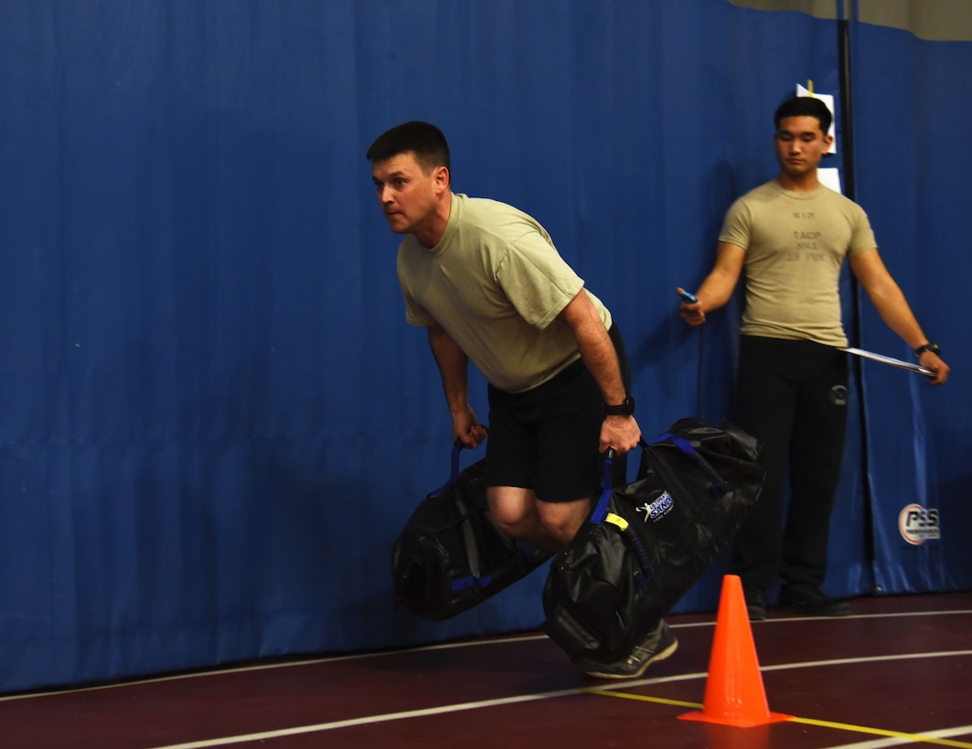 Master Sgt. James Blair, 12th Combat Training Squadron, performs a farmers drag during a strength and agility demonstration as part of the Air Force special operations community's new fitness assessment program at Joint Base Andrews, Md., Jan. 9, 2018. (U.S. Air Force photo by Staff Sgt. Joe Yanik)