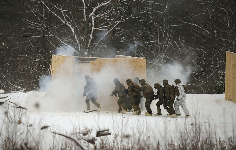 Marines with Company E, 4th Combat Engineer Battalion, 25th Marine Regiment, 4th Marine Division, breach and clear a building during exercise Nordic Frost at Camp Ethan Allen Training Site in Jericho, Vt., Jan. 19, 2018. The exercise allowed Marines to demonstrate their ability to operate in a cold weather mountainous environment, conducting land navigation, marksmanship training, demolitions, call for fire training and other core competencies. (U.S. Marine Corps photo by Pfc. Samantha Schwoch/released)