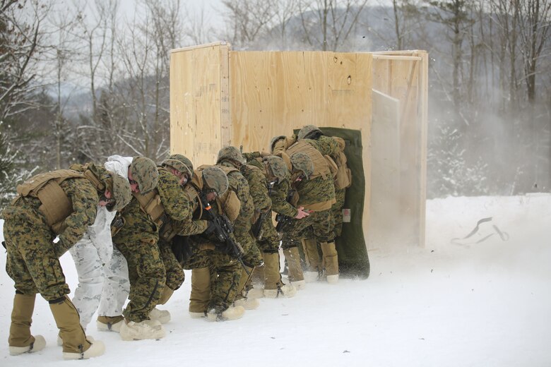 Marines with Company E, 4th Combat Engineer Battalion, 25th Marine Regiment, 4th Marine Division, take cover as a charge is used to breach a building during exercise Nordic Frost at Camp Ethan Allen Training Site in Jericho, Vt., Jan. 19, 2018. The exercise allowed Marines to demonstrate their ability to operate in a cold weather mountainous environment, conducting land navigation, marksmanship training, demolitions, call for fire training and other core competencies. (U.S. Marine Corps photo by Pfc. Samantha Schwoch/released)