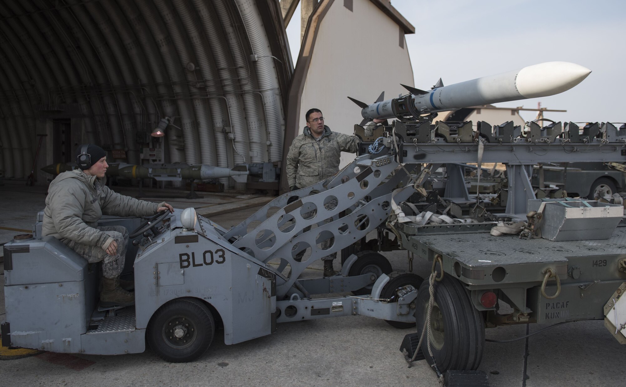 U.S. Air Force Staff Sergeant Christopher Rose and Senior Airman David Botterill, 8th Aircraft Maintenance Squadron weapons load crew member, prepare to load an F-16 Fighting Falcon during an aircraft generation exercise. Members of load crews precisely and promptly loaded over ten aircraft in under 12 hours confirming the Airmen’s abilities to proficiently carry out a concept of operations. Aircraft generations are simulated on a regular basis to confirm the Wolf Pack’s capability maintain mission readiness at all times. (U.S. Air Force photo by Tech. Sgt. Josh Rosales)