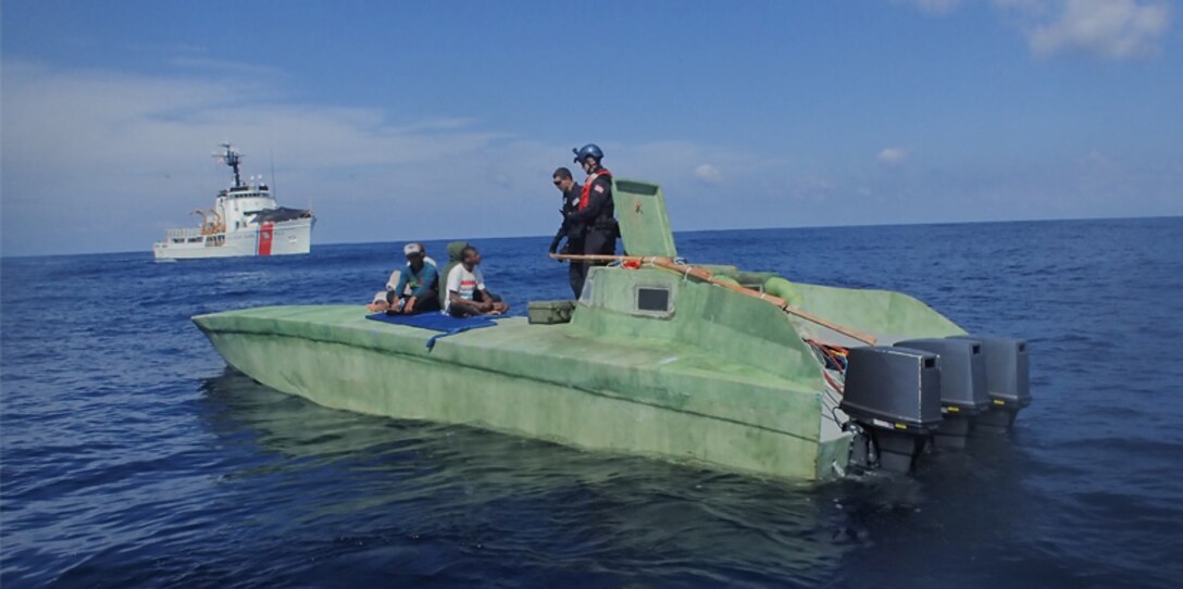 A Coast Guard boarding team members intercept a suspected Low Profile Vessel.