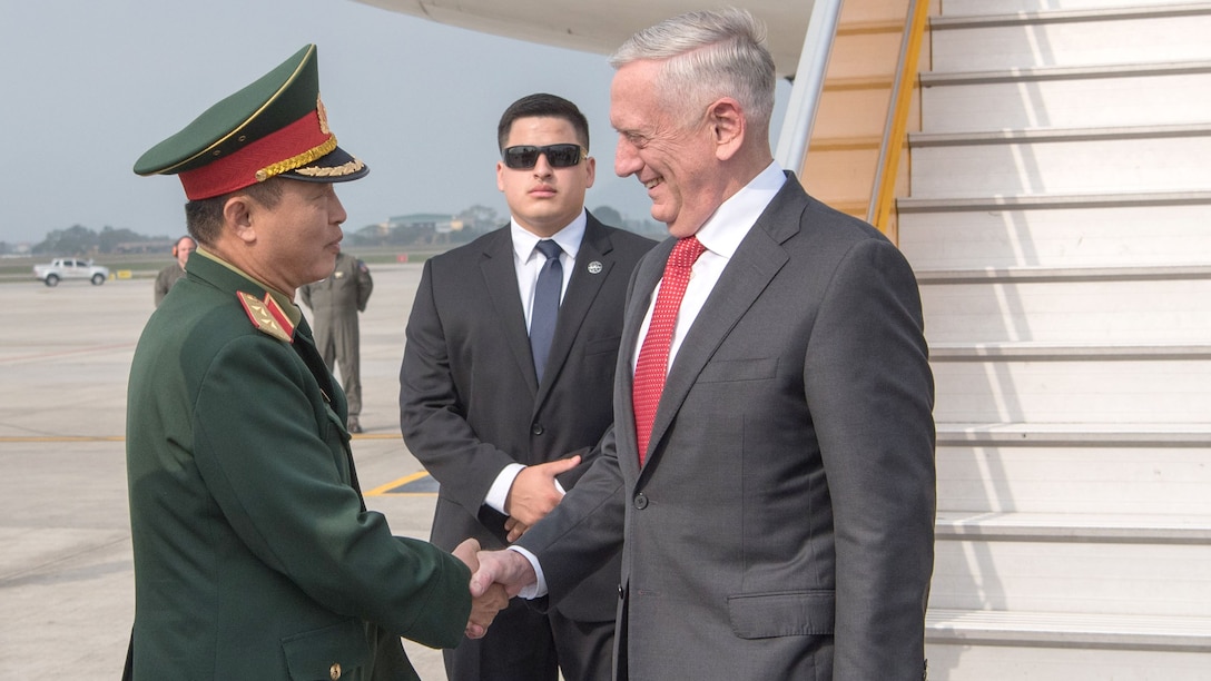Defense Secretary James N. Mattis shakes hands with a member of the Vietnamese military.