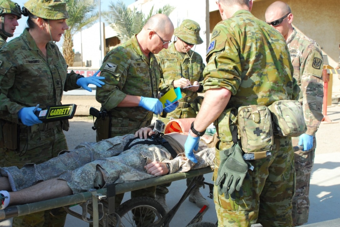 Soldiers assigned to the 449th Combat Aviation Brigade and medical personnel assigned to the Australian army work together to assess a patient’s initial injuries after a simulated gas bottle explosion during a mass casualty training exercise at Camp Taji, Iraq, Jan. 18, 2018. This training is part of the overall Combined Joint Task Force Operation Inherent Resolve building partner capacity mission which focuses on training and improving the capability of partnered forces fighting the Islamic State of Iraq and Syria. Army photo by Staff Sgt. Leticia Samuels