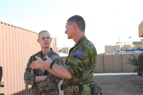 Medical soldiers from the United States and Australia discuss procedures during a mass-casualty exercise in Iraq.