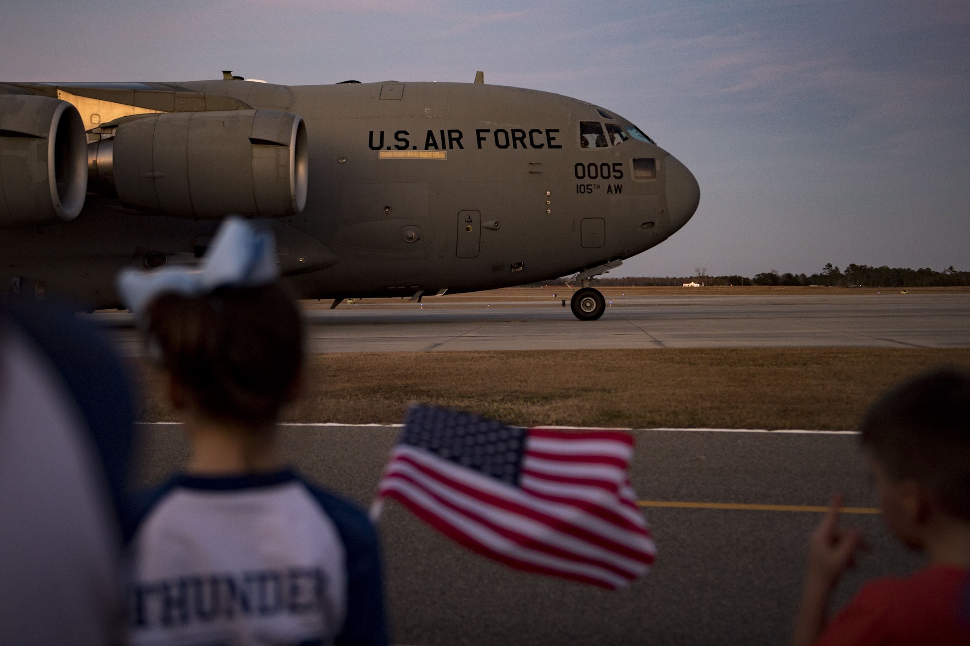 Families and friends wait for their loved ones to exit a C-17 Globemaster III during a redeployment, Jan. 23, 2018, at Moody Air Force Base, Ga. Airmen from the 74th Fighter Squadron and 23d Maintenance Group returned home after a seven-month deployment in support of Operation Inherent Resolve. (U.S. Air Force photo by Senior Airman Daniel Snider)