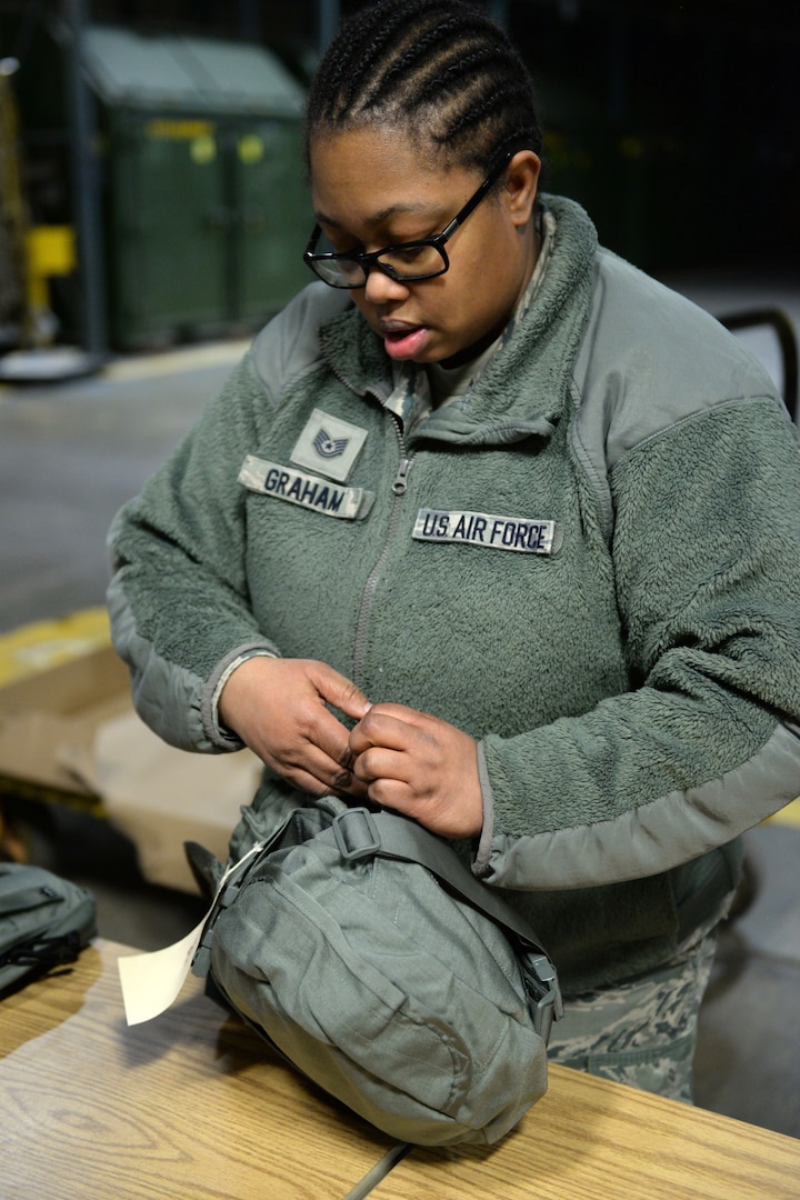 Tech. Sgt. Surnicke Graham, noncommissioned officer in charge of the 673d Logistics Readiness Squadron’s Individual Protective Equipment Element, inspects a mask carrier Jan. 17, 2018, at Joint Base Elmendorf-Richardson, Alaska. The 673d LRS/IPE is responsible for inspecting all chemical, biological, radiological, and nuclear IPE.