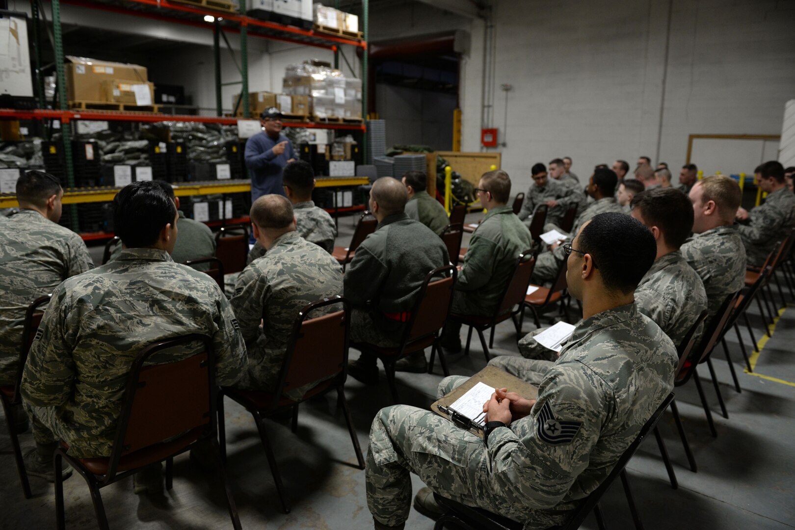 Johnny Foster, 673d Logistics Readiness Squadron Individual Protective Equipment Element Supervisor, speaks to Airmen regarding the issuing of IPE, Jan. 17, 2018, at Joint Base Elmendorf-Richardson, Alaska. IPE takes account of the storage, inventory, inspection, and issue of mobility bags, and base mobility small arms/light weapons.