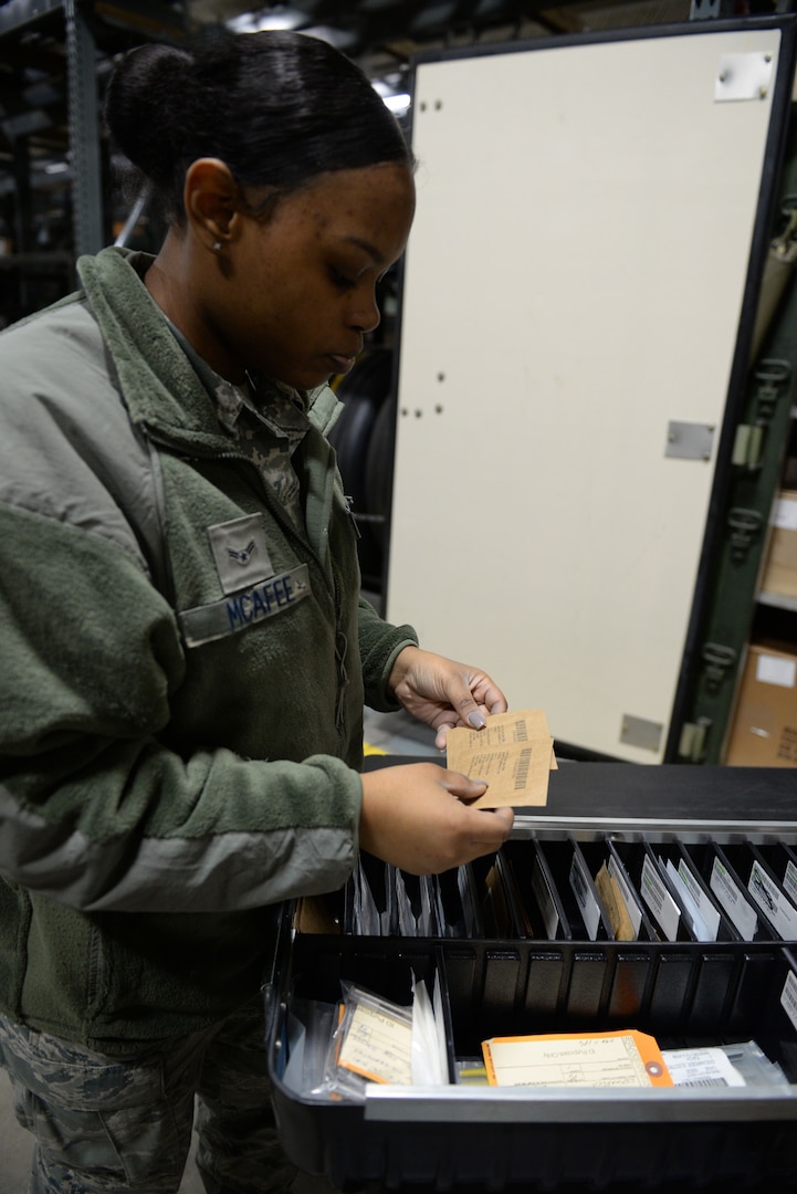 Airman 1st Class Nekail McAffee, 673d Logistics Readiness Squadron physical inventory journeyman, checks inventory to maintain accountability of products, Jan. 17, 2018, at Joint Base Elmendorf-Richardson, Alaska. The physical inventory element keeps accountability of all parts, pre-positioning them so when the aircraft needs them, they are ready for issue.
