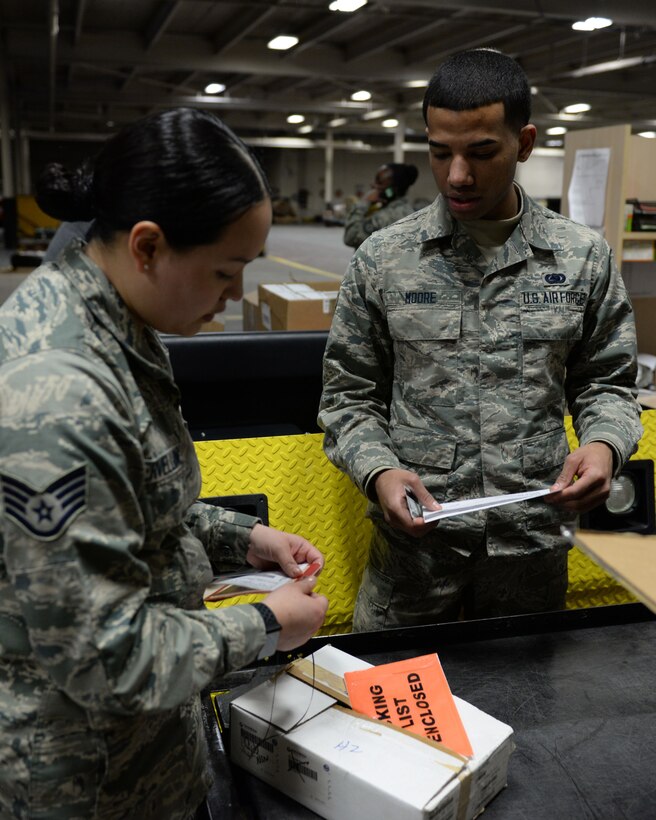 Staff Sgt. AnaMaria Servellon, assistant noncommissioned officer in charge of the 673d Logistics Readiness Squadron’s flight service center and Airman 1st Class Trevion Moore, 673d Logistics Readiness Squadron flight service center journeyman, verify tagging information of parts, Jan. 18, 2018, at Joint Base Elmendorf-Richardson, Alaska. The FSC serves as the primary point of contact with all units from everything from a road paver to an electronic part for an aircraft regarding repairs and repair cycle management.