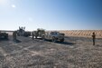 1072nd Transportation Company Soldiers work with 115th Signal Battalion Soldiers to rapidly unload a generator, a satellite transportable terminal, and two humvees during an emergency deployment readiness exercise, or EDRE, Jan. 12, 2018, on Udairi Range Complex near Camp Buehring, Kuwait.