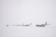 A row of C-130J Super Hercules sit on the flightline during a snow storm, Jan. 22, 2018, at Yokota Air Base, Japan.
