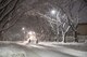 An Airman with the 374th Civil Engineer Squadron plows the bases streets of freshly fallen snow with a 120-M grader, Jan. 22, 2018, at Yokota Air Base, Japan.