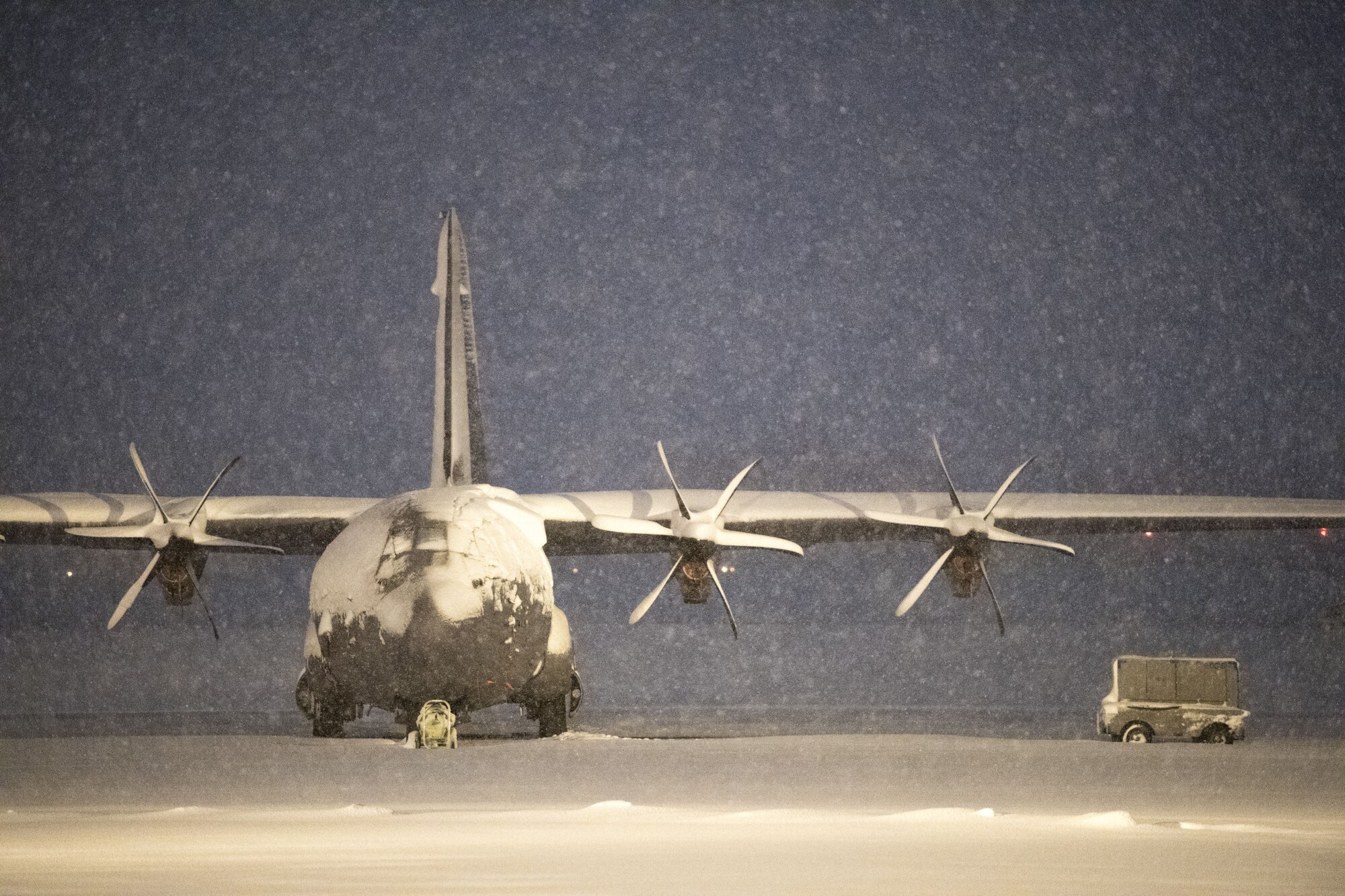 A C-130J Super Hercules sits on the flightline during a snow storm, Jan. 22, 2018, at Yokota Air Base, Japan.