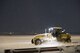 An Airmen with the 374th Civil Engineer Squadron works to plow the flighline of newly fallen snow with a 120-M grader late into the night, Jan. 22, 2018, at Yokota Air Base, Japan.