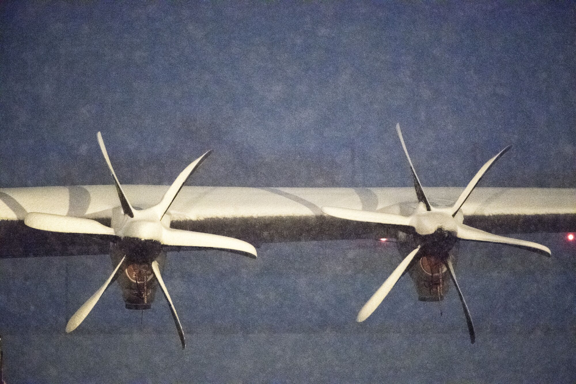 Snow rests atop the wing and propellers of a C-130J Super Hercules, Jan. 22, 2018, at Yokota Air Base, Japan.