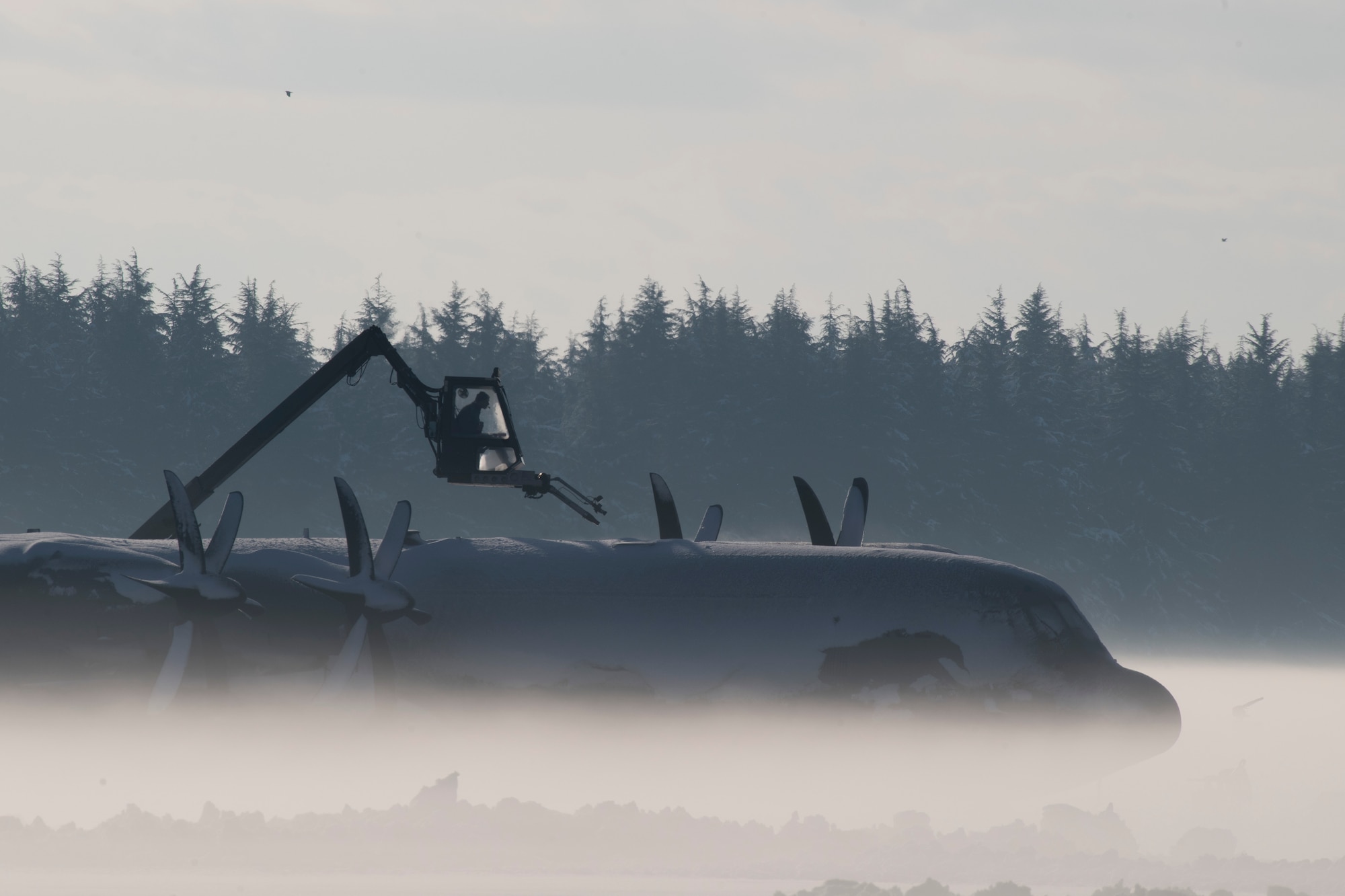 An Airman with the 374th Maintenance Group works to de-ice a C-130J Super Hercules, Jan. 23, 2018, at Yokota Air Base, Japan.
