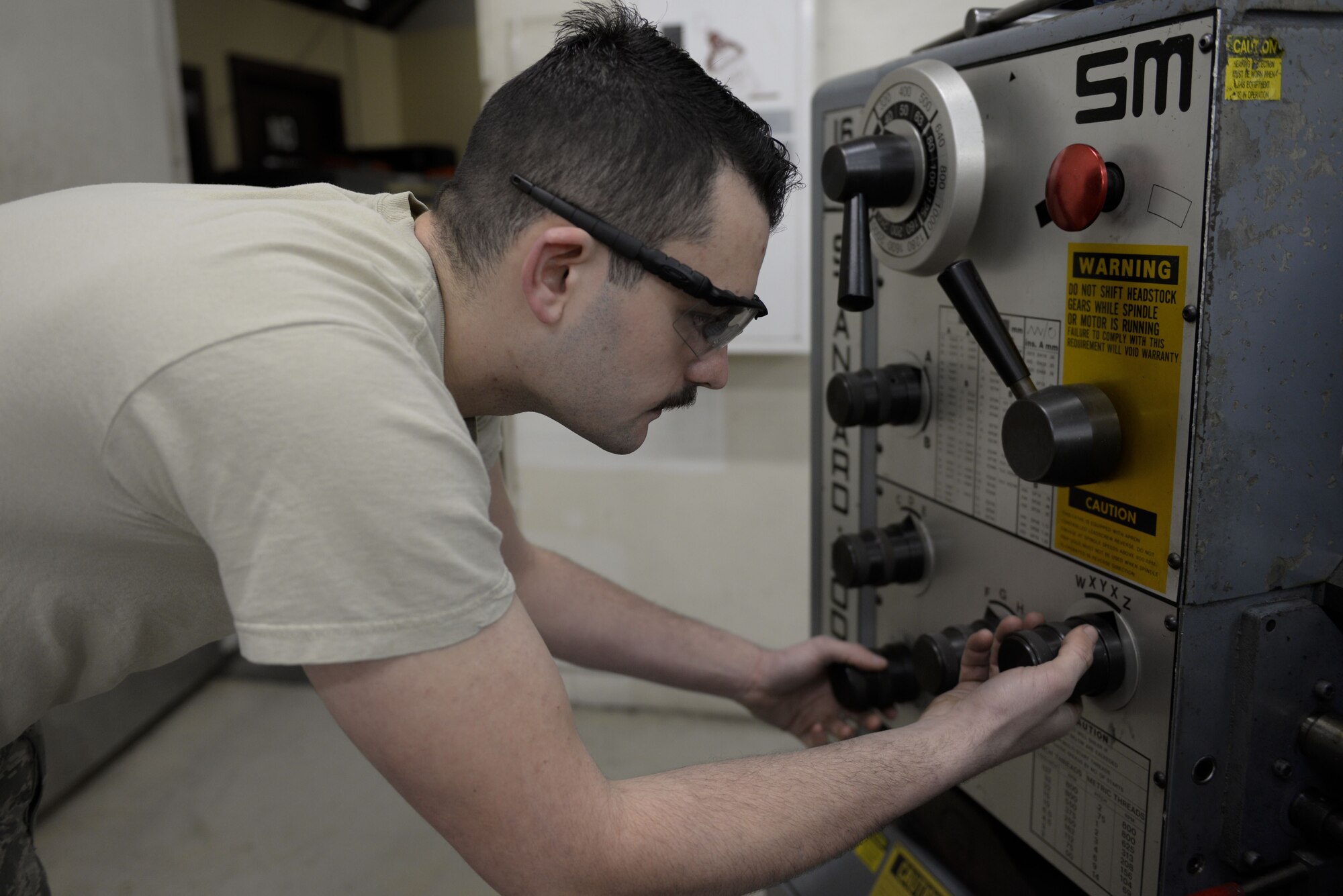 Senior Airman David Petrich, 374th Maintenance Squadron aircraft metals technology fabricator, demonstrates how to use a lathe, Jan. 24, 2018, at Yokota Air Base, Japan.