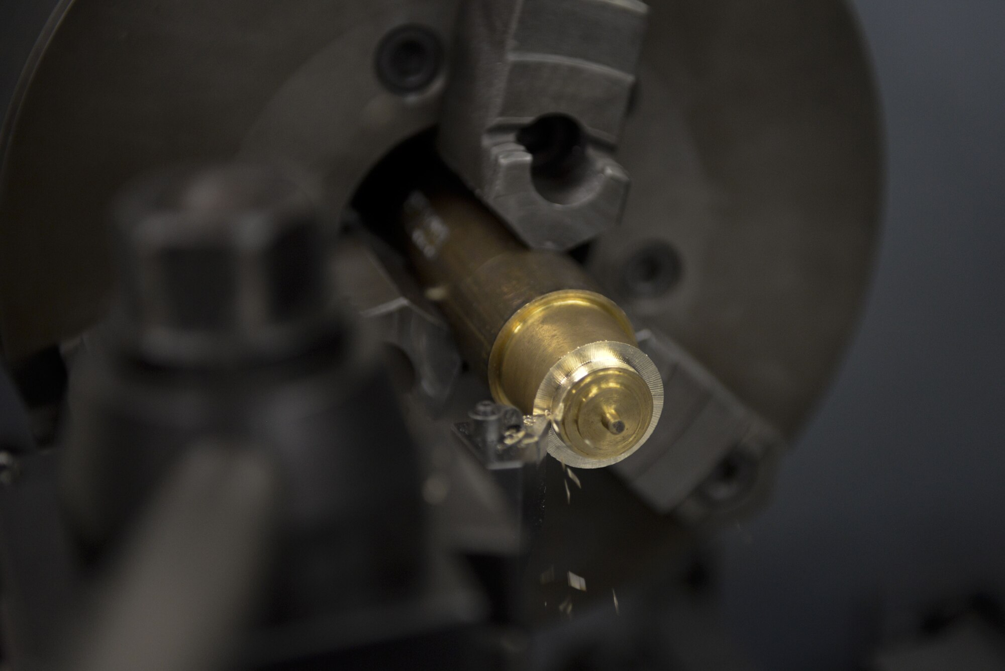 A lathe slowly cuts metal during a 374th Maintenance Squadron aircraft metals technology shop lathe demonstration, Jan. 24, 2018, at Yokota Air Base, Japan.