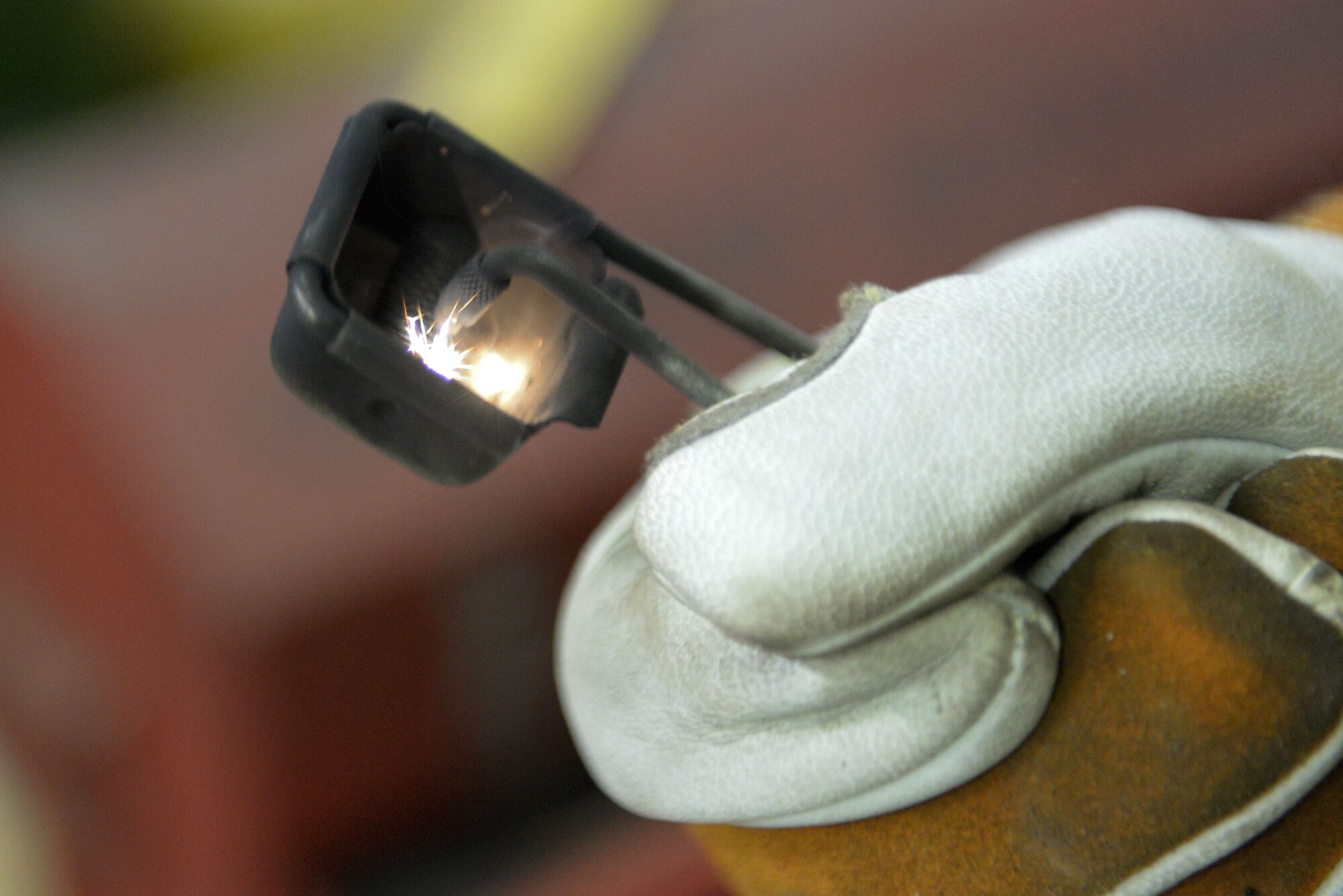 Senior Airman David Petrich, 374th Maintenance Squadron aircraft metals technology fabricator, sparks a torch striker, Jan. 24, 2018, at Yokota Air Base, Japan.