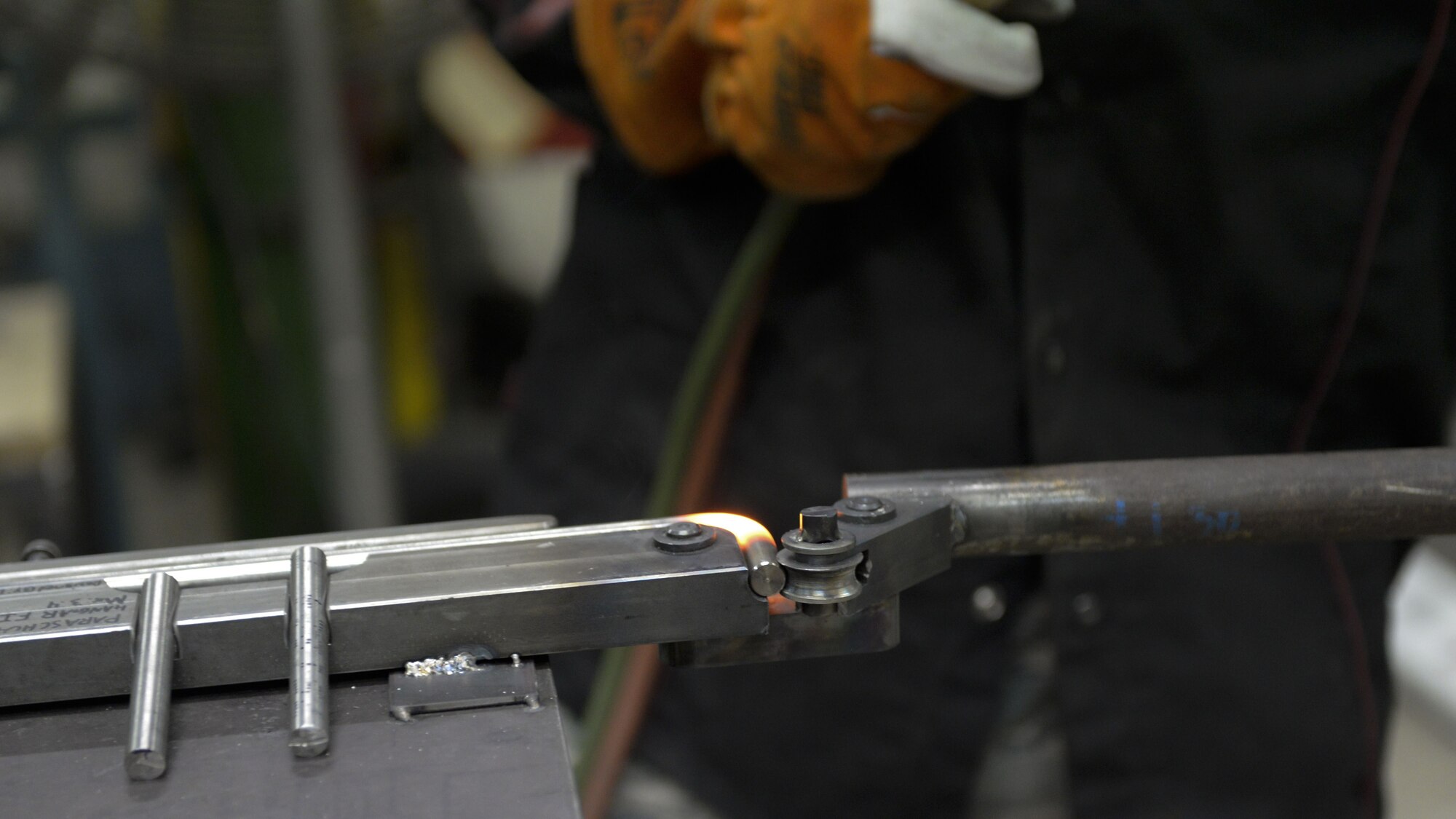 Senior Airman David Petrich, 374th Maintenance Squadron aircraft metals technology fabricator, bends a red-hot metal rod to build a parachute rack, Jan. 24, 2018, at Yokota Air Base, Japan.