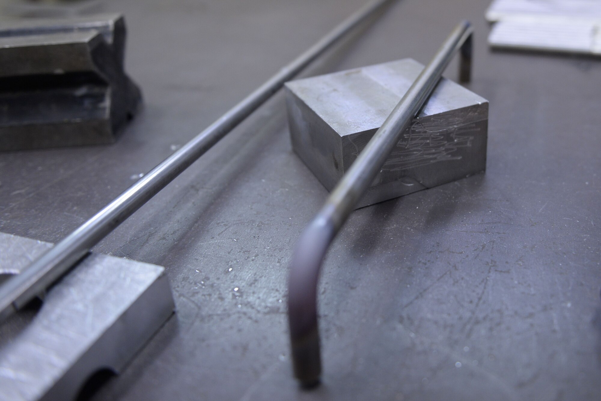 A metal rod used to create a parachute rack, cools on a work table, Jan. 24, 2018, at Yokota Air Base, Japan.