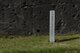 A memorial marker placed in front of the remnants of an embattled bunker on the island of Iwo To, Japan.