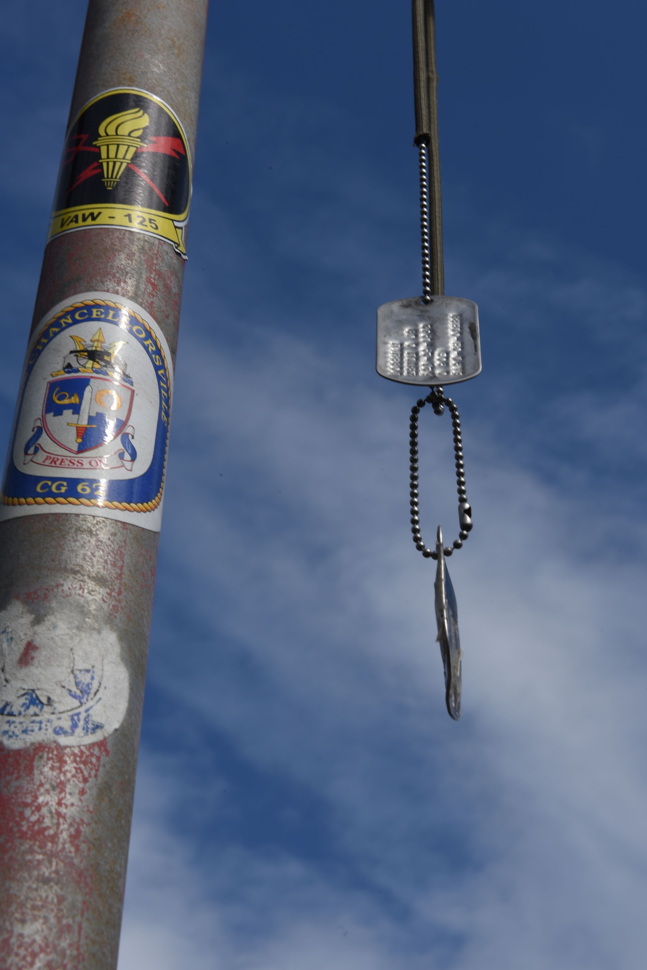 Dog tags rest in front of the Marine memorial atop Mount Suribachi Jan. 24, 2017 on the island of Iwo To, Japan.