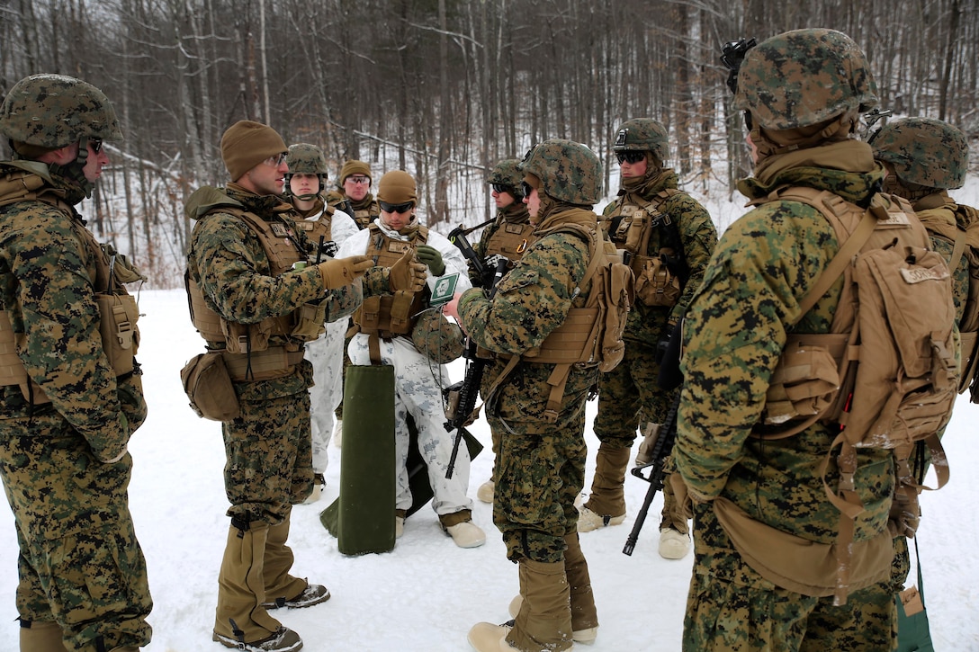 Capt. Clinton Snow, center left, briefs Marines on the safety procedures before conducting breach training.