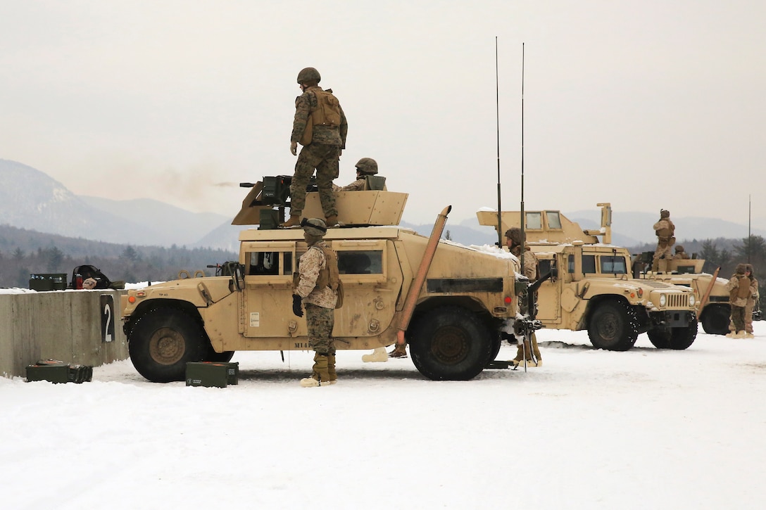 Marines fire mounted MK-19 grenade launchers from the top turrets on Humvees.