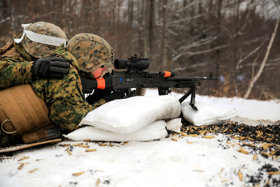 Marine Corps Lance Cpls. Doug Poyner, foreground, and Orlando Pena fire the M240 machine gun.