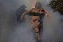 Corpsmen with 2nd Medical Battalion, 2nd Marine Logistics Group, carry a simulated casualty through smoke during a Tactical Combat Casualty Care training exercise at Camp Lejeune, N.C. Jan. 22, 2018. TCCC is designed to help corpsmen practice basic medical techniques while in a stressful environment. The corpsmen are evaluated with simulated battlefield scenarios overseen by instructors. (U.S. Marine Corps photo by Pfc. Nicholas Guevara)