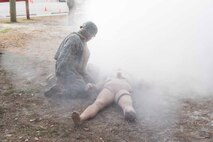 Petty Officer 2nd Class Michael Ramirez with 2nd Medical Battalion, 2nd Marine Logistics Group, assesses a simulated casualty after a simulated explosive charge detonates during a Tactical Combat Casualty Care training exercise at Camp Lejeune, N.C. Jan. 22, 2018. TCCC is designed to help corpsmen practice basic medical techniques while in a stressful environment. The corpsmen are evaluated with simulated battlefield scenarios overseen by instructors. (U.S. Marine Corps photo by Pfc. Nicholas Guevara)