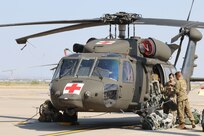 A flight crew from 1st Armored Division Combat Aviation Brigade prepares their UH-60M Black Hawk prior to deploying to East Texas in support of the Hurricane Harvey relief efforts.