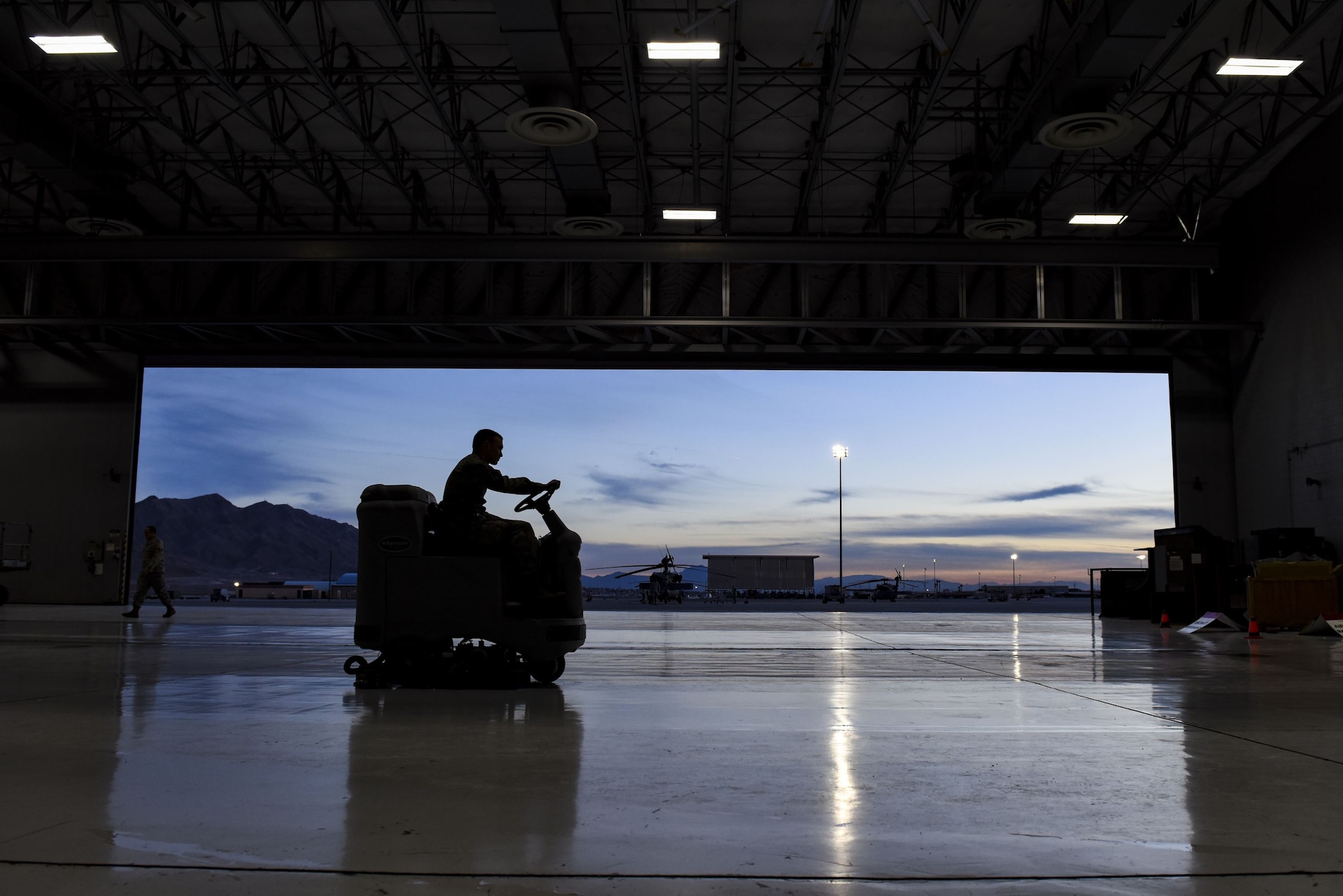 Airman 1st Class Charles Curran, 823rd Maintenance Squadron electrical environmental apprentice, uses a floor scrubber at Nellis Air Force Base, Nev., Jan. 5, 2018. Floor scrubbers remove dust, oil and grease to maintain a safe and clean work environment. (U.S. Air Force photo by Airman 1st Class Andrew D. Sarver)