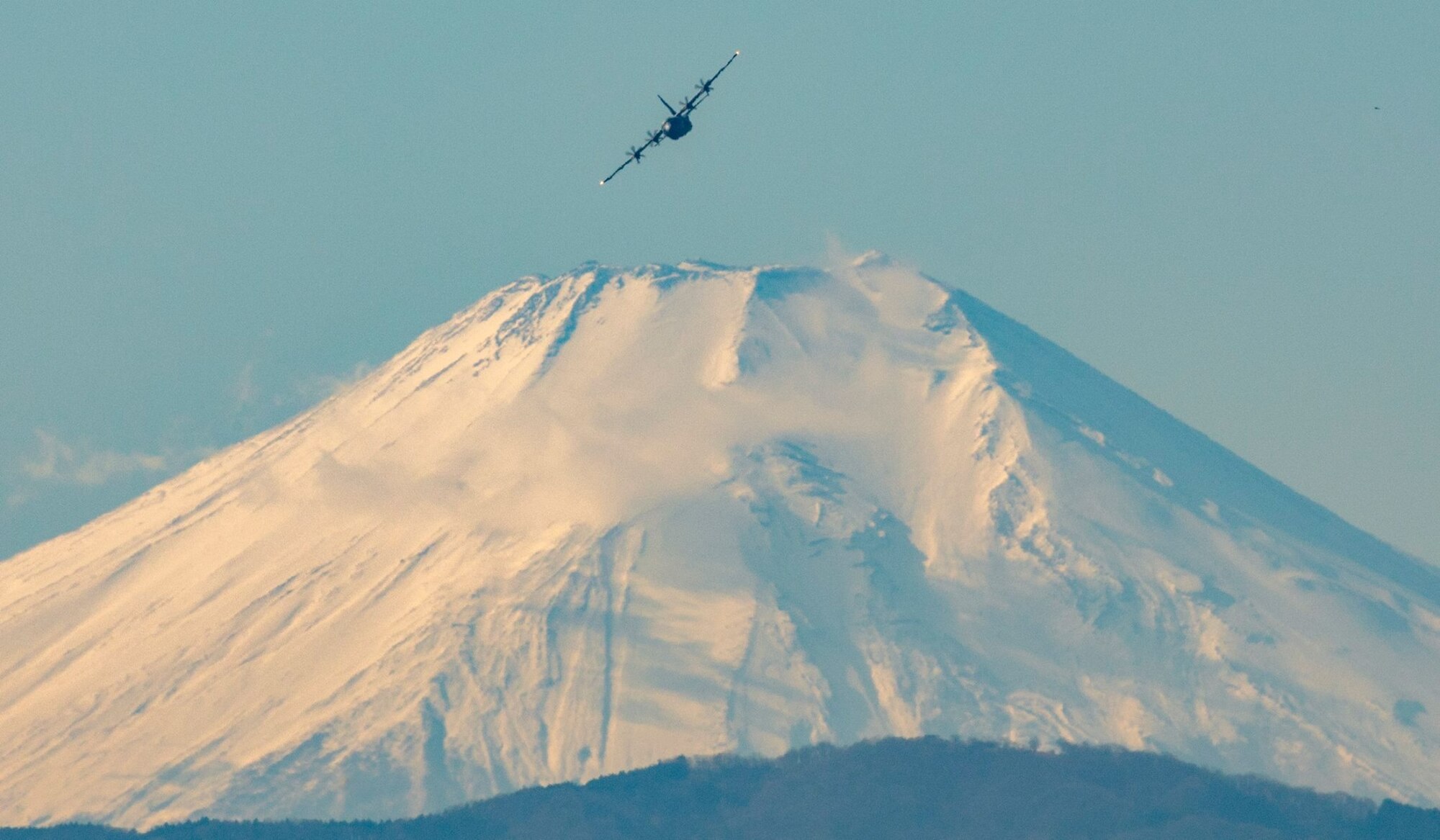 A C-130J Super Hercules assigned to the 36th Airlift Squadron flies near Mt. Fuji, Japan, during a routine sortie, Jan. 12, 2018 at Yokota Air Base, Japan. The 36th AS regularly conducts training missions to remain proficient in the necessary skills to support any contingency. (U.S. Air Force photo by Yasuo Osakabe)