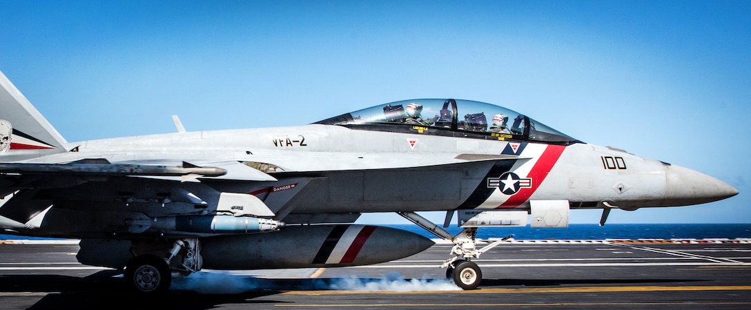 Navy Capt. Tom Barber, commander, Carrier Air Wing 2, and Cmdr. Jason Hutcherson, commander, Strike Fighter Squadron 2, complete their 1,000th carrier arrested landing.