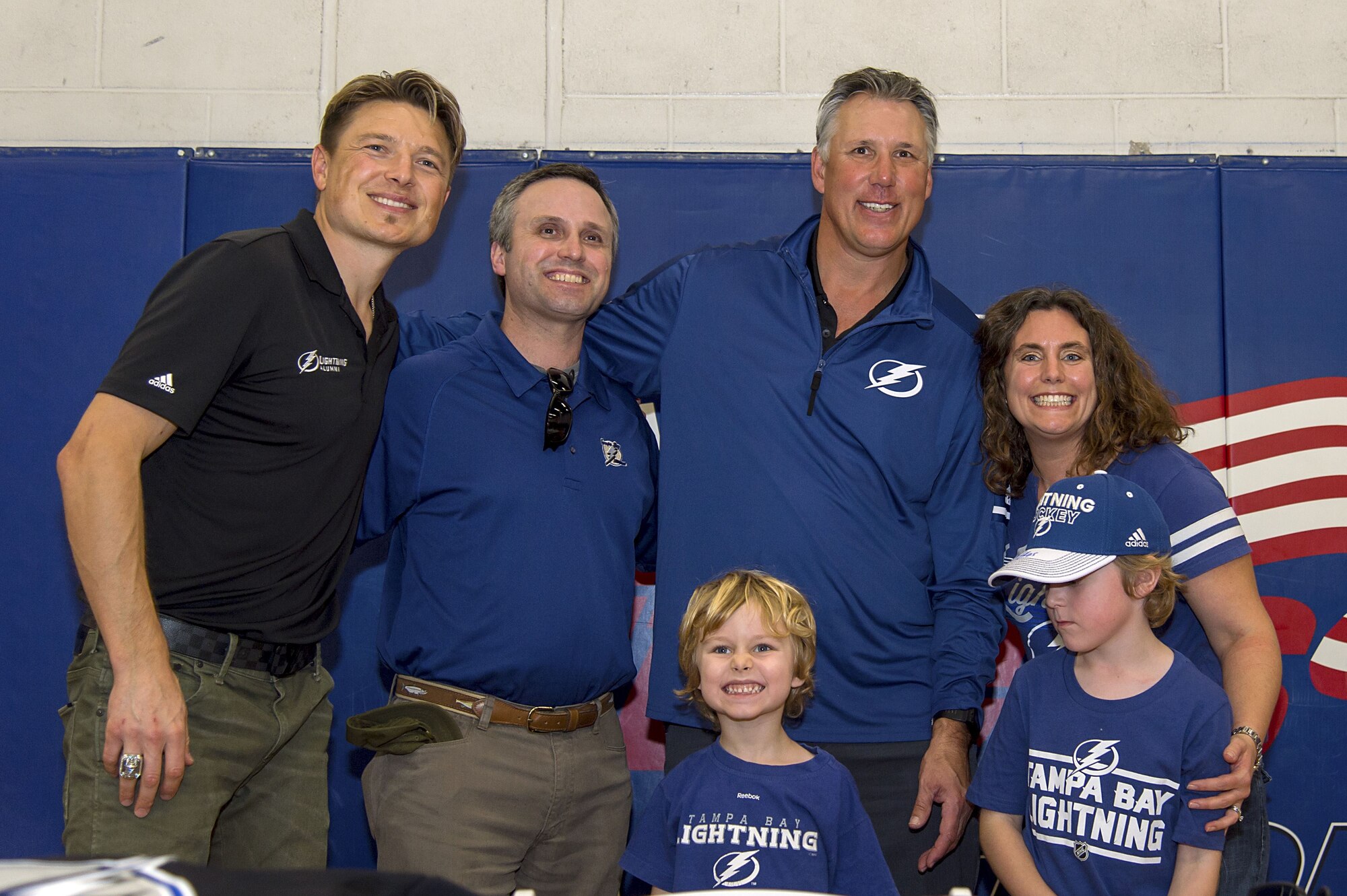 A family pauses for a photo with former Tampa Bay Lightning players, Ruslan Fedetenko and Dave Andreychuk, during their visit to MacDill Air Force Base, Fla., Jan. 24, 2018. The former players visited ahead of the National Hockey League All-Star game, which is scheduled to be held at AMALIE Arena, Tampa , Fla.