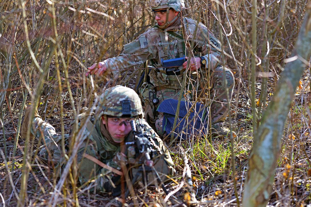 Paratroopers wait from cover for their target to get into position.