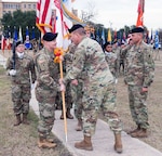 Maj. Gen. Mark Stammer (middle), commander, U.S. Army South, passes the colors to the new incoming Army South Command Sgt. Maj. William Rinehart (left), as outgoing Command Sgt. Maj. Carlos Olvera (right) looks on at Joint Base San Antonio-Fort Sam Houston Jan. 5.