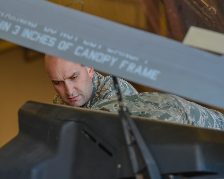 Tech. Sgt. Joseph Scalise, 56th Component Maintenance Squadron egress systems technician, performs safety checks on the canopy of an F-35A Lightning II before the removal of an ejection seat at Luke Air Force Base, Ariz., Jan. 11, 2018. All F-35s and partner nation aircraft at Luke are scheduled to receive new ejection seat modifications in the near future. (U.S. Air Force photo/Airman 1st Class Caleb Worpel)