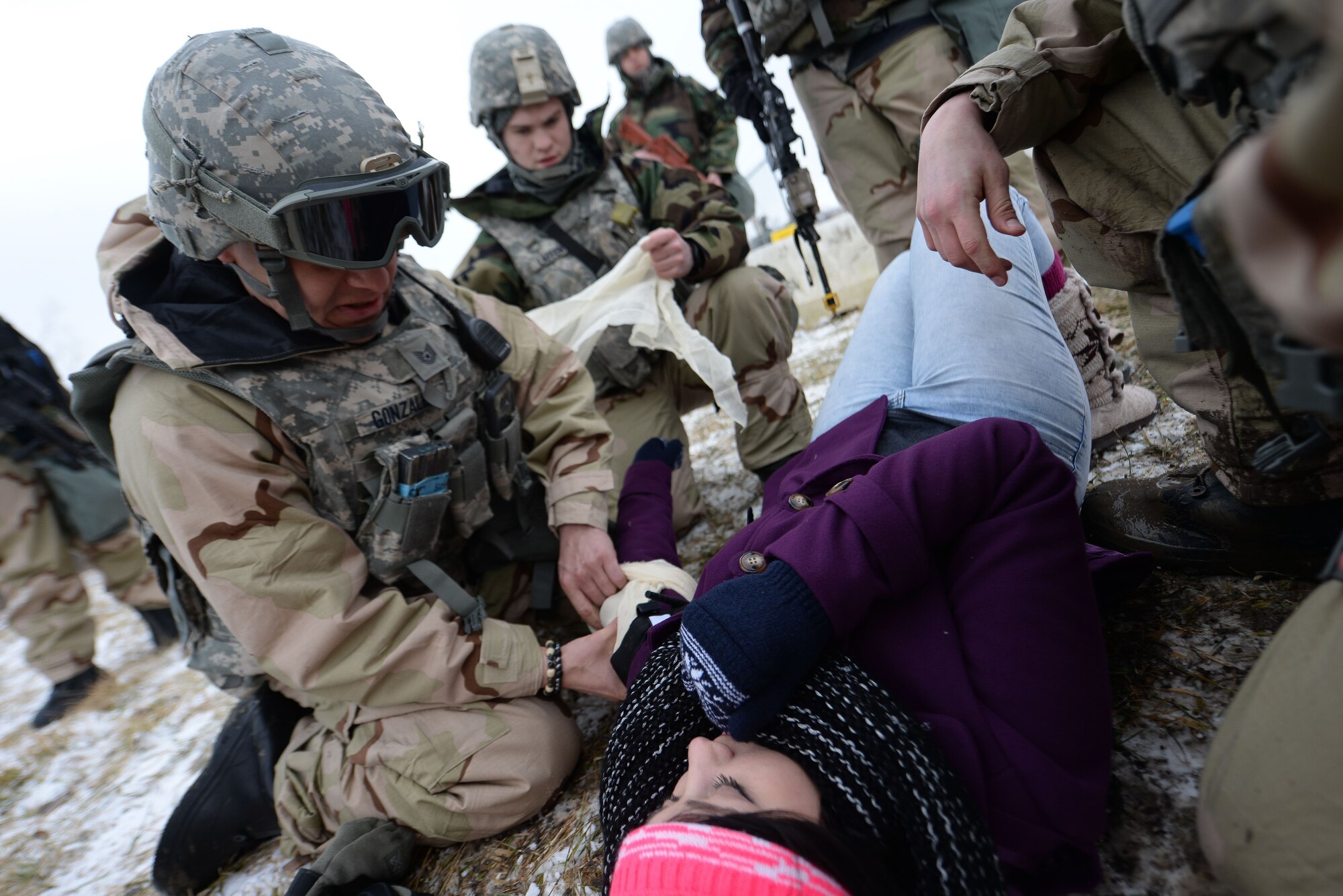 Members of the 55th Security Forces Squadron perform self aid buddy care on an individual during an operational readiness exercise at Offutt Air Force Base, Nebraska, Jan. 23, 2018. The exercise tested the 55th Wing’s readiness and ability to meet wartime and contingency taskings.